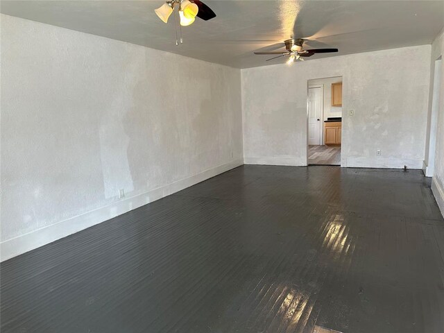 314 N Maryland Ave, Mangum, OK 73554 - unfurnished room featuring a ceiling fan, baseboards, and wood finished floors
