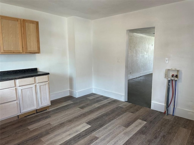 314 N Maryland Ave, Mangum, OK 73554 - unfurnished dining area with baseboards and dark wood finished floors