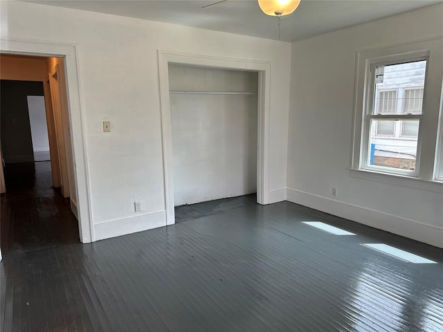 314 N Maryland Ave, Mangum, OK 73554 - unfurnished bedroom with dark wood-type flooring, baseboards, and a closet