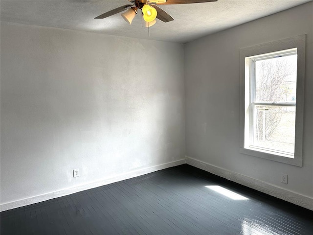 314 N Maryland Ave, Mangum, OK 73554 - spare room with dark wood-style floors, a textured ceiling, baseboards, and a ceiling fan