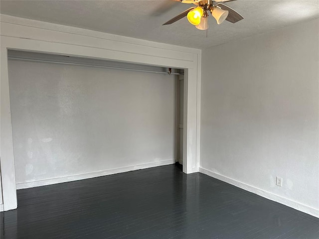 314 N Maryland Ave, Mangum, OK 73554 - unfurnished bedroom featuring baseboards, dark wood-style flooring, a closet, and a ceiling fan