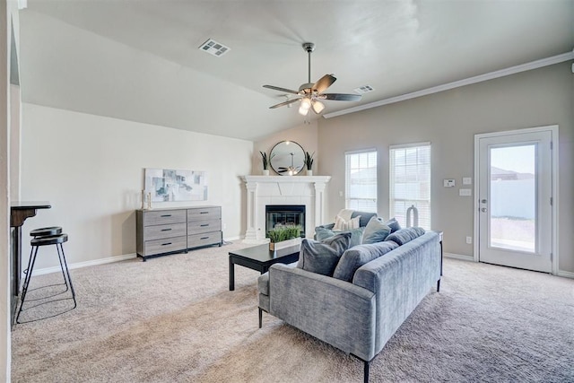 living room featuring visible vents, a ceiling fan, carpet, and a glass covered fireplace