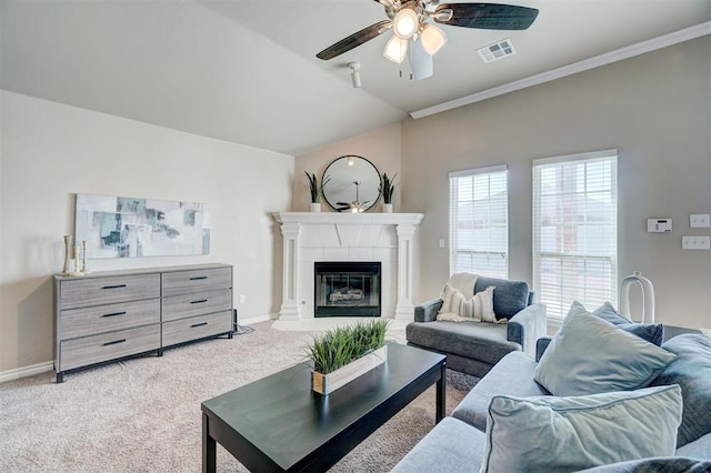 living area with ceiling fan, a fireplace, visible vents, light carpet, and baseboards