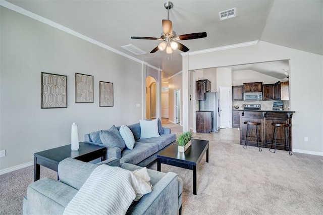 living area with crown molding, visible vents, ceiling fan, and vaulted ceiling