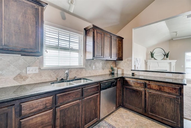 kitchen with stainless steel dishwasher, a sink, lofted ceiling, and a wealth of natural light