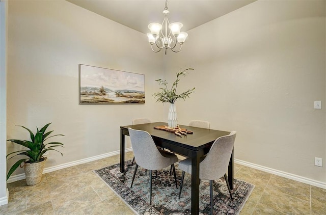 dining room featuring a chandelier and baseboards