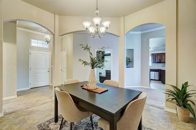 dining room featuring arched walkways, an inviting chandelier, and crown molding