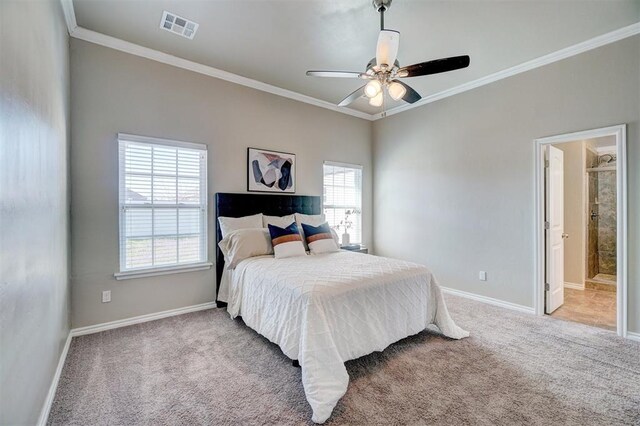 carpeted bedroom with visible vents, baseboards, ceiling fan, crown molding, and connected bathroom