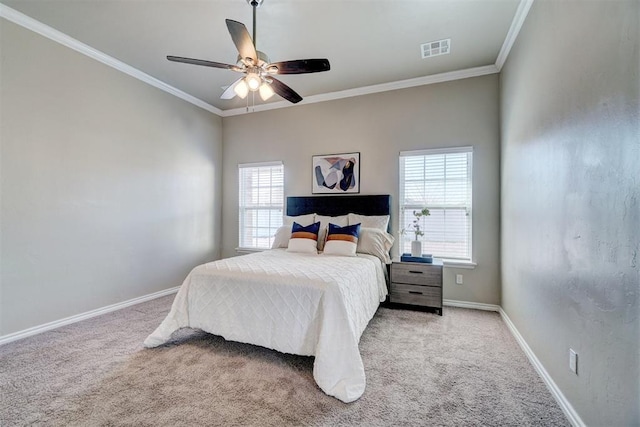 bedroom with carpet, visible vents, baseboards, and crown molding