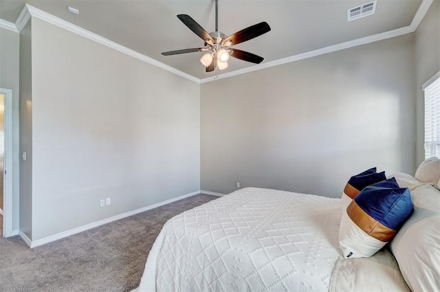 carpeted bedroom featuring visible vents, baseboards, and crown molding
