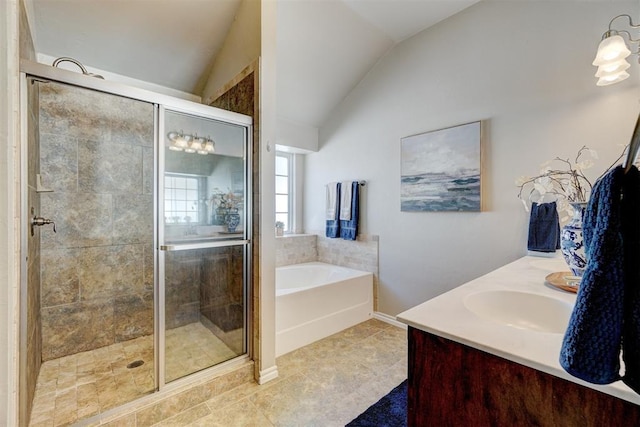 bathroom with vanity, a bath, a stall shower, and lofted ceiling