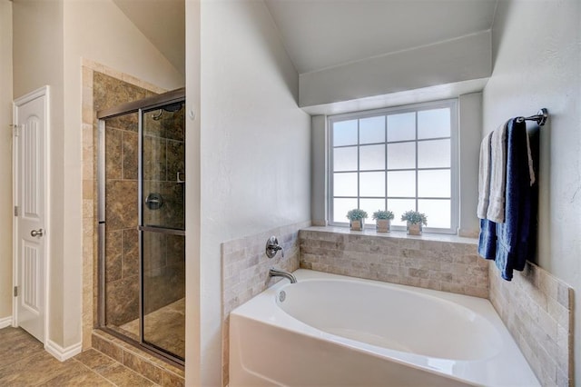 full bath featuring a bath, a stall shower, and lofted ceiling