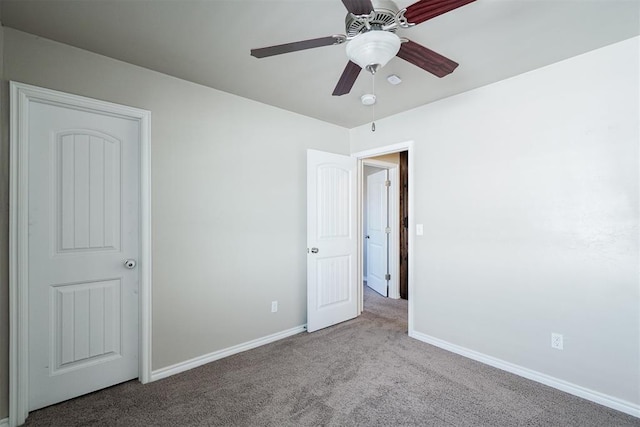 unfurnished bedroom with baseboards, a ceiling fan, and carpet floors