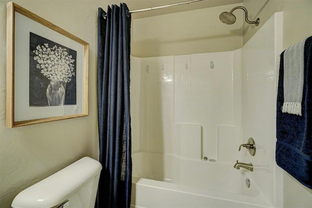 bathroom with toilet, a textured wall, and shower / tub combo with curtain