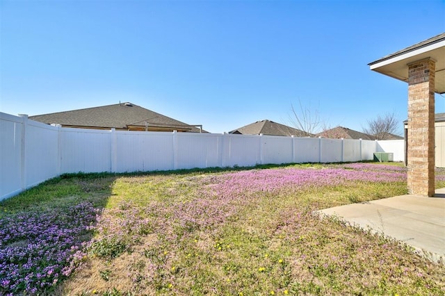 view of yard with a fenced backyard