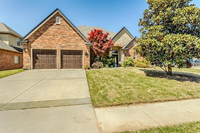 4316 Spyglass Dr, Norman, OK 73072 - view of front of home with a front yard, an attached garage, brick siding, and concrete driveway