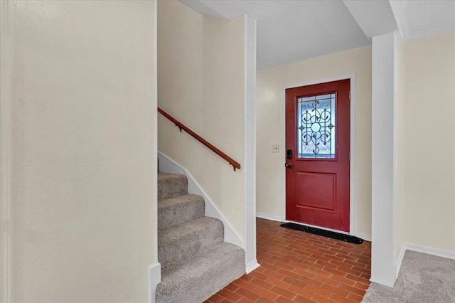 6706 N Woodward Dr, Oklahoma City, OK 73116 - entrance foyer featuring baseboards, stairway, and brick patterned flooring