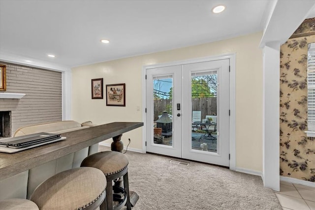 6706 N Woodward Dr, Oklahoma City, OK 73116 - doorway with french doors, baseboards, a brick fireplace, recessed lighting, and light tile patterned flooring