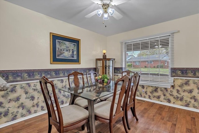 6706 N Woodward Dr, Oklahoma City, OK 73116 - dining area with wallpapered walls, wood finished floors, ceiling fan, and baseboards