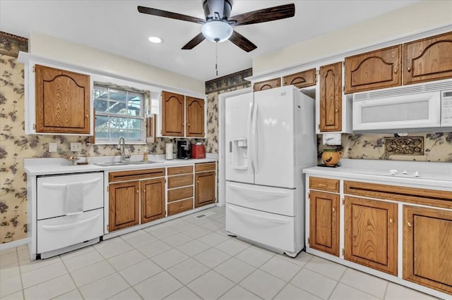 6706 N Woodward Dr, Oklahoma City, OK 73116 - kitchen featuring white appliances, a sink, brown cabinets, ceiling fan, and wallpapered walls