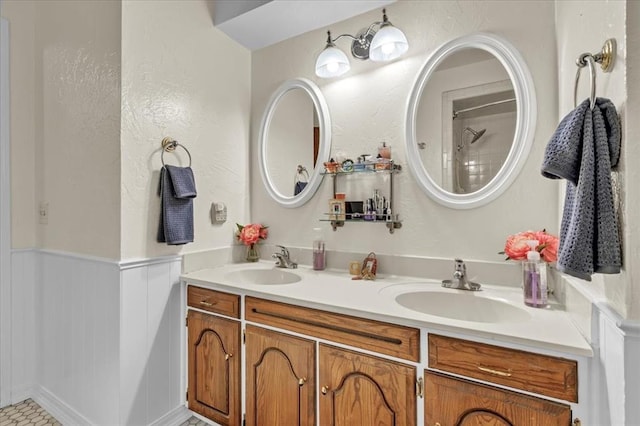 6706 N Woodward Dr, Oklahoma City, OK 73116 - bathroom with a wainscoted wall and double vanity
