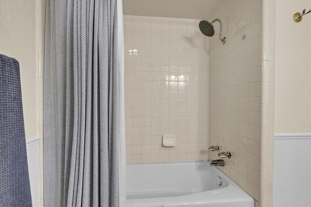 6706 N Woodward Dr, Oklahoma City, OK 73116 - bathroom featuring a wainscoted wall and shower / tub combo with curtain