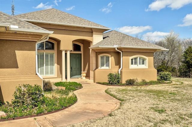 815 River View Dr, Norman, OK 73071 - property entrance featuring a shingled roof, a lawn, and stucco siding