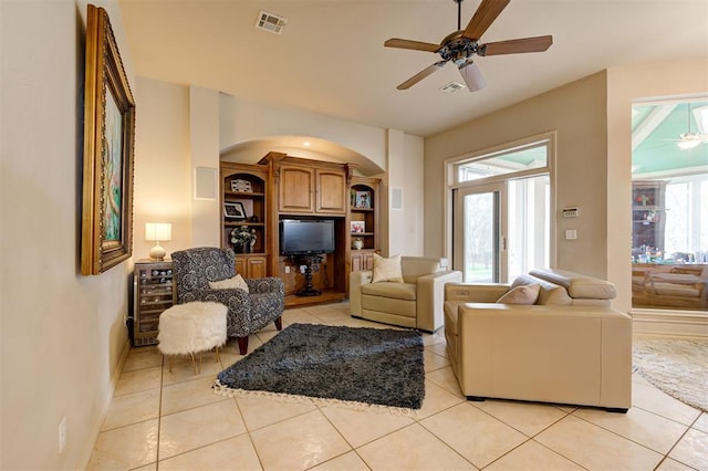 815 River View Dr, Norman, OK 73071 - living area with visible vents, arched walkways, ceiling fan, and light tile patterned floors