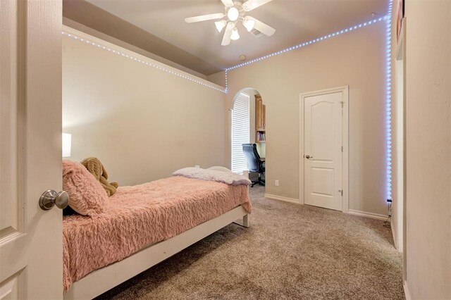815 River View Dr, Norman, OK 73071 - carpeted bedroom featuring arched walkways, baseboards, and ceiling fan