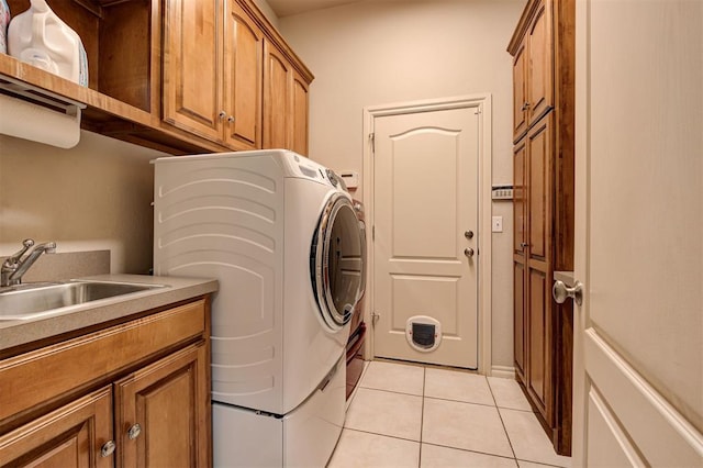 815 River View Dr, Norman, OK 73071 - washroom featuring cabinet space, a sink, independent washer and dryer, and light tile patterned floors