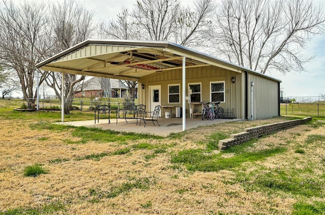 815 River View Dr, Norman, OK 73071 - rear view of property featuring board and batten siding, a yard, fence, and a patio area