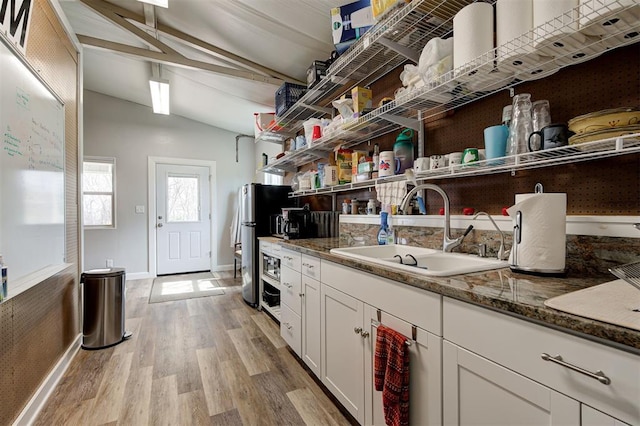 815 River View Dr, Norman, OK 73071 - kitchen with light wood-style flooring, a sink, lofted ceiling with beams, and open shelves