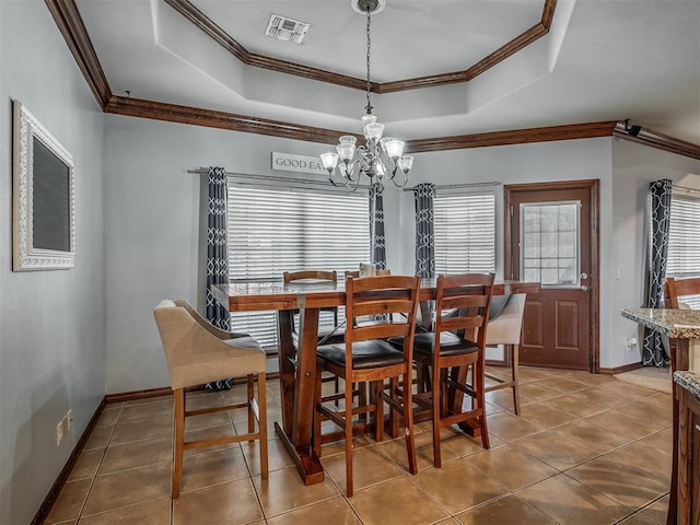 tiled dining area with visible vents, a chandelier, a healthy amount of sunlight, crown molding, and a tray ceiling