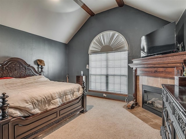 carpeted bedroom featuring a fireplace, ceiling fan, and lofted ceiling with beams