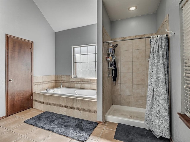 full bathroom featuring a shower stall, tile patterned flooring, vaulted ceiling, and a garden tub