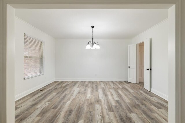 6200 N Styll Rd, Oklahoma City, OK 73112 - spare room with a chandelier, light wood-type flooring, crown molding, and baseboards