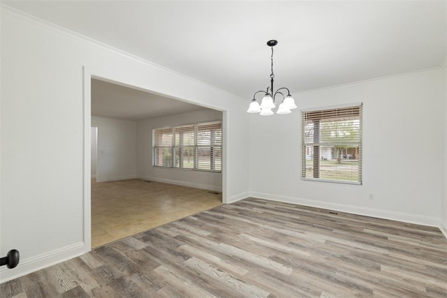 6200 N Styll Rd, Oklahoma City, OK 73112 - spare room with ornamental molding, a chandelier, wood finished floors, and baseboards