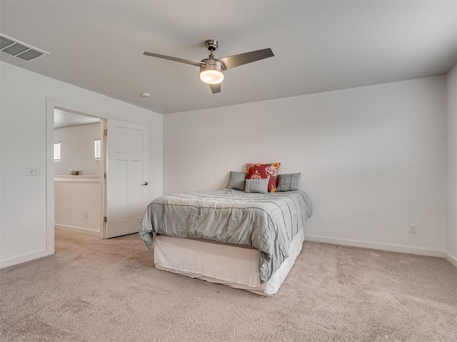 carpeted bedroom featuring visible vents, baseboards, and ceiling fan