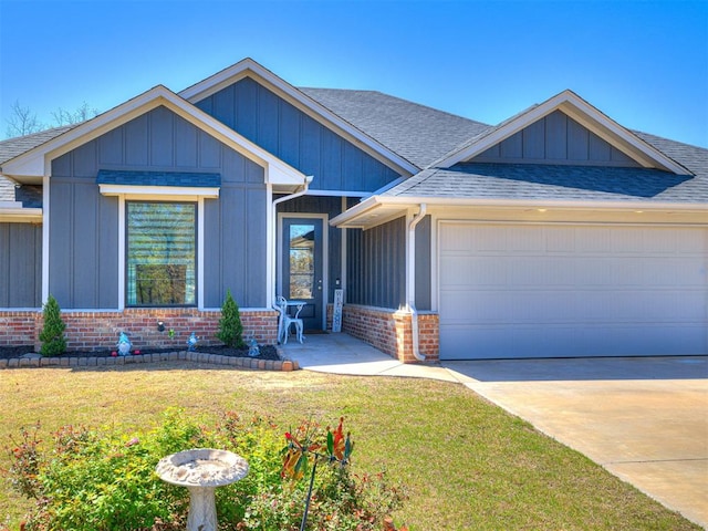 21608 SE 95th St, Mcloud, OK 74851 - view of front of home with a shingled roof, an attached garage, brick siding, a front lawn, and concrete driveway