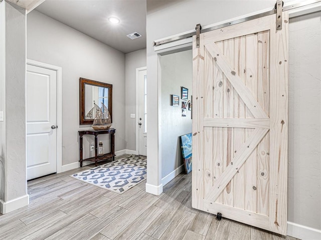 21608 SE 95th St, Mcloud, OK 74851 - entryway featuring a barn door, light wood-style flooring, and baseboards