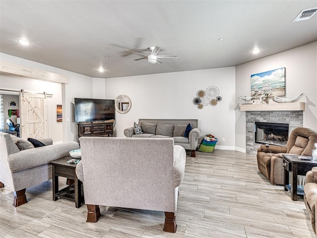 21608 SE 95th St, Mcloud, OK 74851 - living area with recessed lighting, a barn door, light wood-style flooring, a ceiling fan, and baseboards