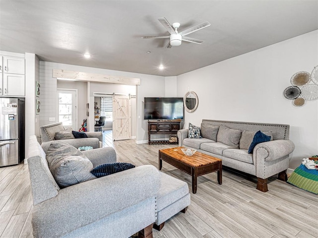 21608 SE 95th St, Mcloud, OK 74851 - living room featuring light wood-type flooring, a ceiling fan, a barn door, and recessed lighting