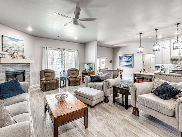 21608 SE 95th St, Mcloud, OK 74851 - living area featuring a ceiling fan, recessed lighting, baseboards, light wood finished floors, and a brick fireplace