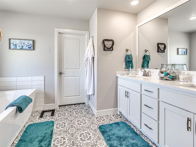 21608 SE 95th St, Mcloud, OK 74851 - bathroom with double vanity, a bathtub, baseboards, tile patterned flooring, and recessed lighting