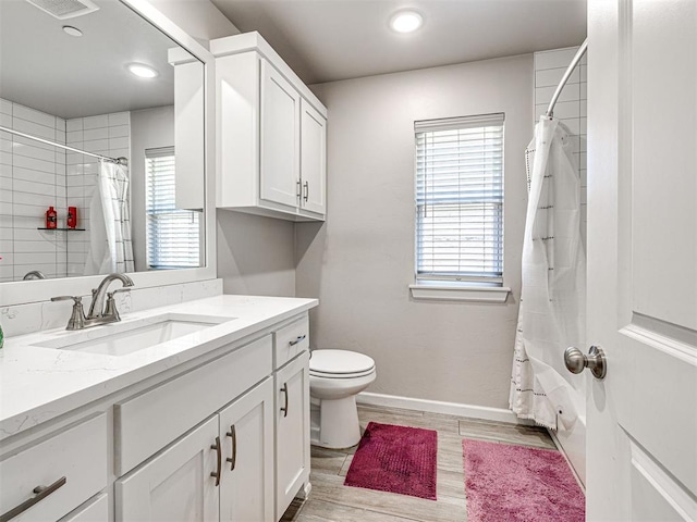 21608 SE 95th St, Mcloud, OK 74851 - bathroom with vanity, toilet, recessed lighting, wood finished floors, and baseboards