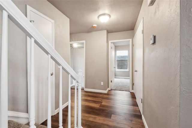 entryway featuring baseboards and wood finished floors