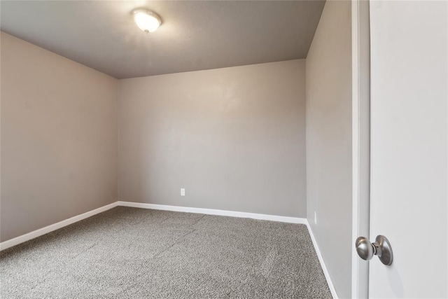 unfurnished room with baseboards and carpet