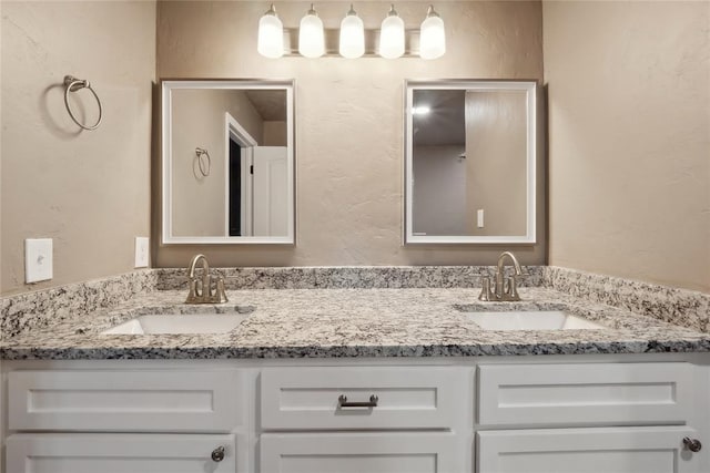bathroom with a sink and double vanity