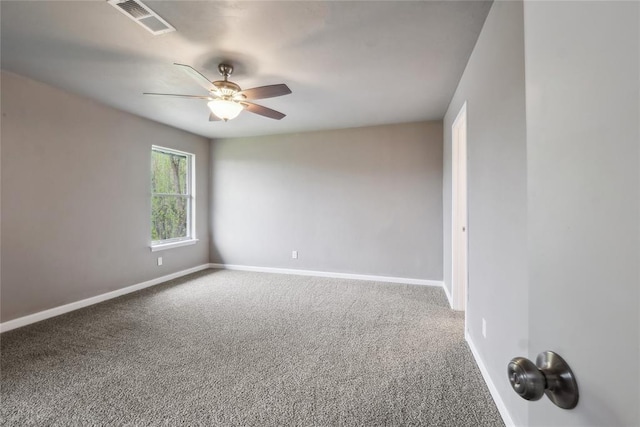 unfurnished room featuring carpet floors, visible vents, a ceiling fan, and baseboards