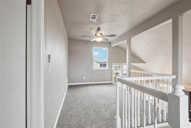 hallway featuring lofted ceiling with beams, baseboards, visible vents, and carpet floors